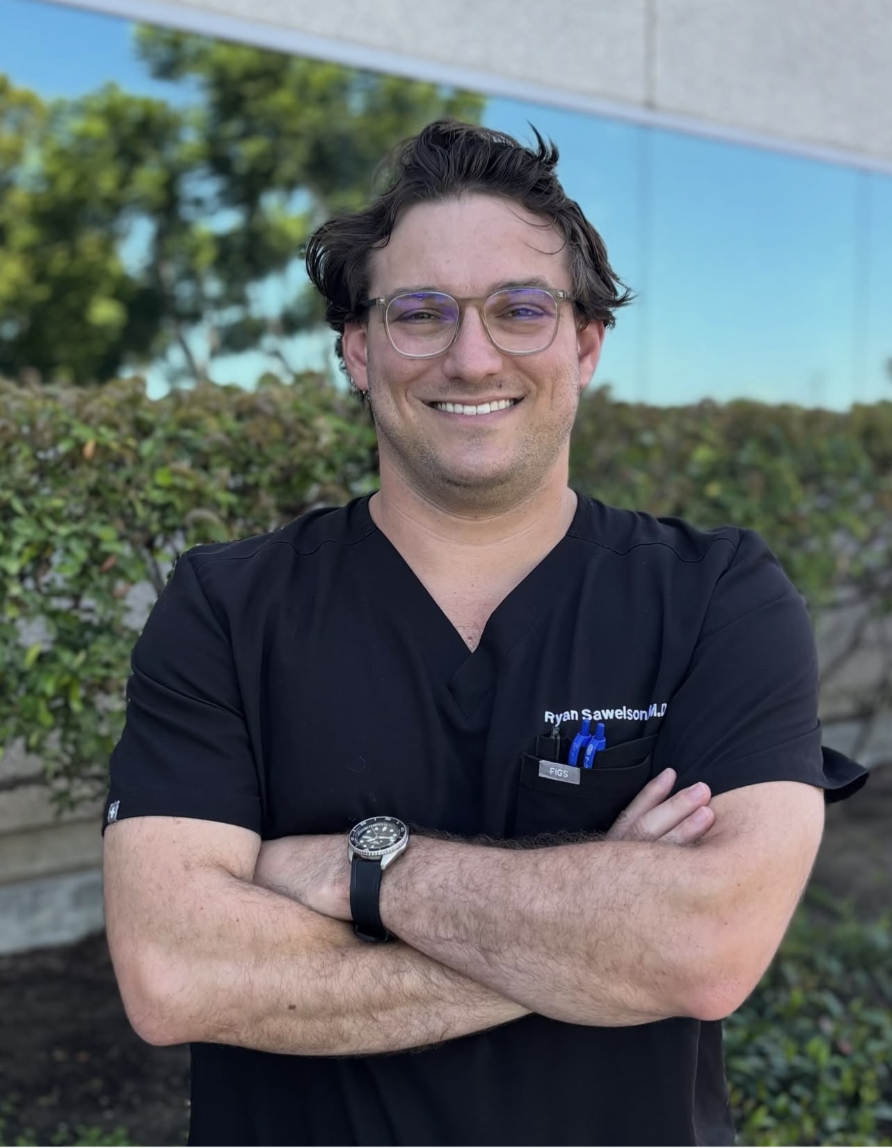 Dr. Ryan Sawelson smiling in scrubs
